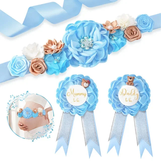 A set of blue floral maternity sash and corsage pins featuring roses and baby leaves.