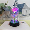 Rose de verre éternelle avec éclairage LED rose et violet sur une base noire.