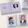 A clear plastic photo card album binder featuring a purple and white design with a heart-shaped cutout and a photo card insid