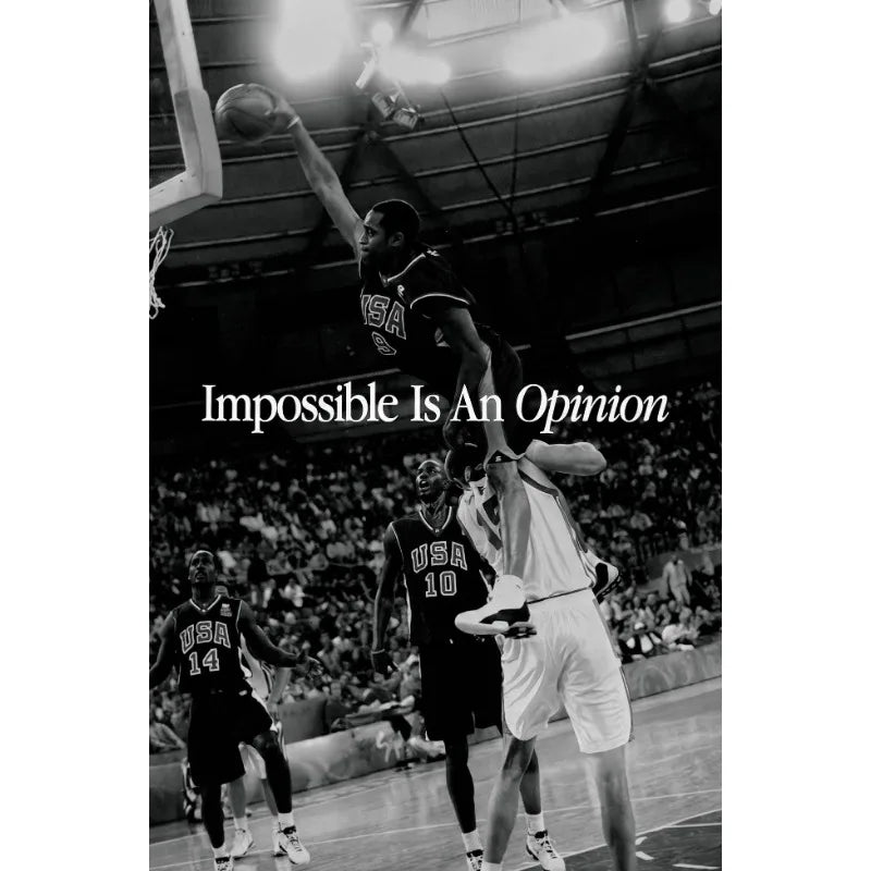 A black and white photo of a basketball player in action during a game.