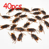 40 pieces of plastic cockroach gag toys scattered on a white background