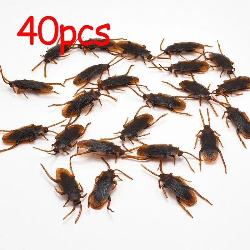 40 pieces of plastic cockroach gag toys scattered on a white background