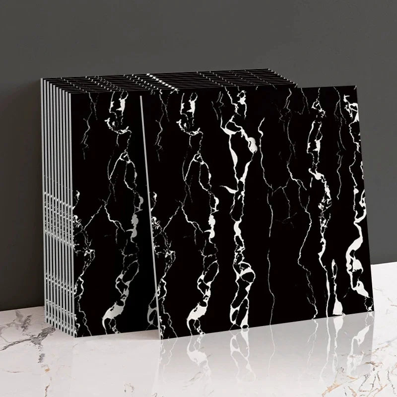 Black marble peel-and-stick wall panels with white veining displayed on a white surface.