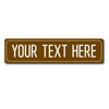 A rectangular, bronze-colored metal sign with the text YOUR TEXT HERE engraved on it.