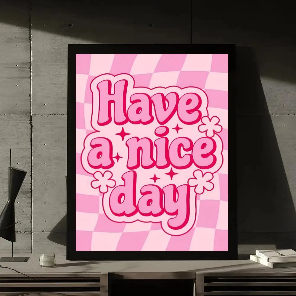 A framed wall art print featuring the pink checkered pattern and the text Have a nice day in bright pink lettering.