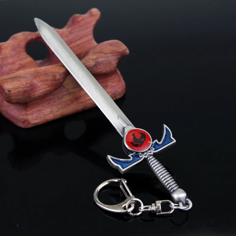 A silver Thundercats metal lion mark sword keychain with a red and blue blade and a textured handle.
