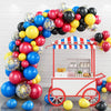 A balloon garland arch kit featuring colorful balloons and star foil accents displayed in a white booth setting.
