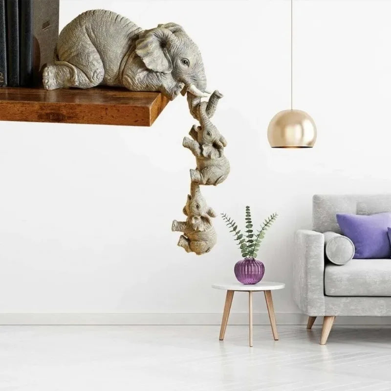 A resin figurine of an elephant hugging a baby, hanging from a wooden shelf.