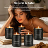 A woman is relaxing while holding a set of black scented candles, including vintage oak and lavender woods scents.