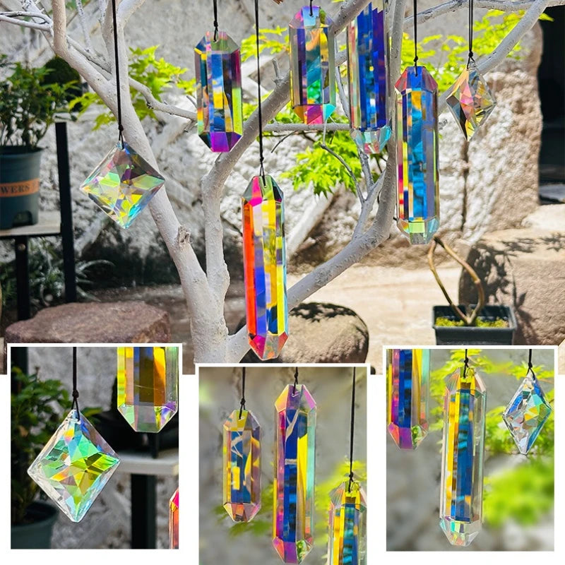 A set of seven crystal prism sun catchers hanging from a tree branch in an outdoor garden setting.