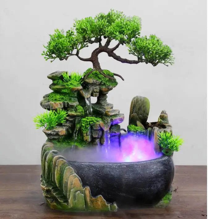Resin waterfall desktop fountain with LED lighting featuring a mossy rock landscape and glowing purple water.