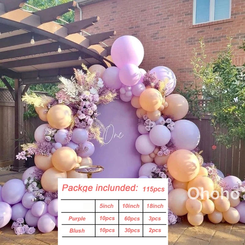 A purple and peach balloon garland featuring various sized balloons arranged on a wooden structure.
