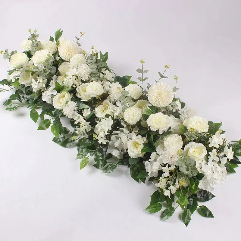 A lush arrangement of white artificial roses and greenery for event decor.