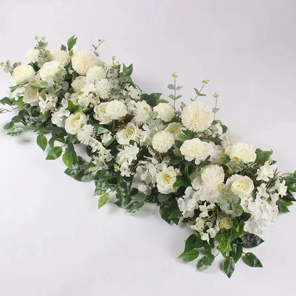 A lush arrangement of white artificial roses and greenery for event decor.