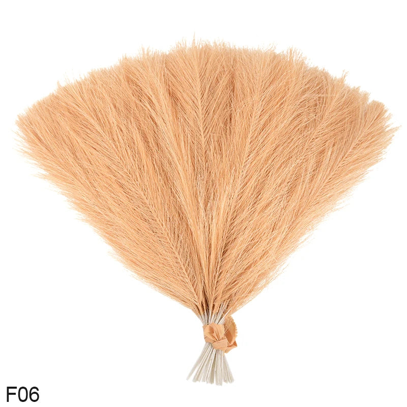 A bundle of light tan artificial pampas grass reeds used for home and event decoration.