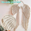 Handwoven angel wing macrame wall hanging made of natural fiber with fringe details.