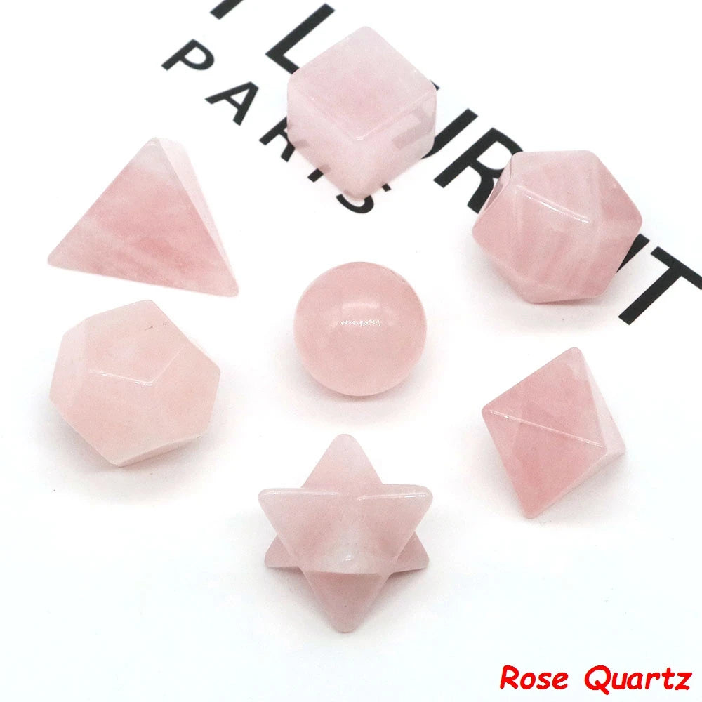 A collection of pink rose quartz crystals in various geometric shapes and sizes for healing and meditation.