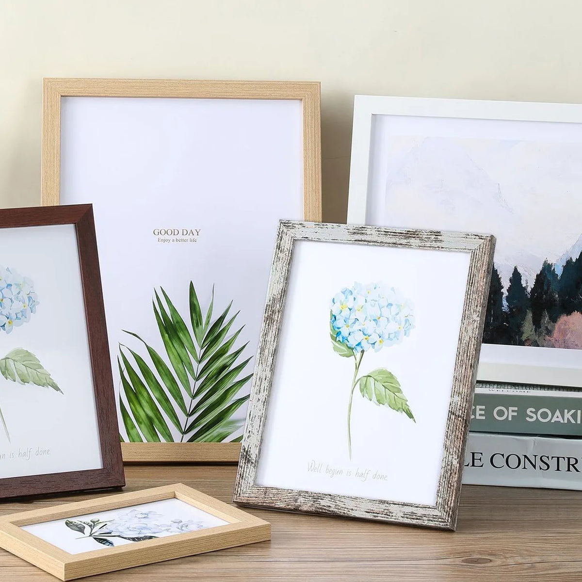 A set of five rustic wooden photo frames displaying floral and botanical prints on a light background.
