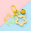 A yellow padlock keychain with a clear star-shaped charm pendant on a light blue background.