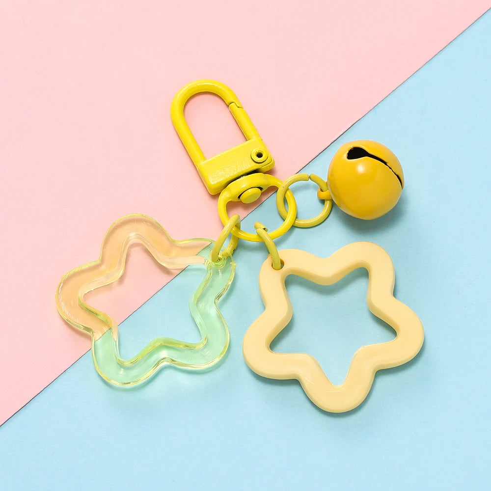 A yellow padlock keychain with a clear star-shaped charm pendant on a light blue background.