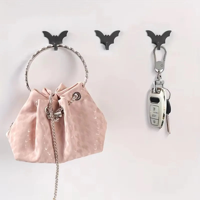 A set of five black gothic bat adhesive hooks for keys and bags displayed against a white background.