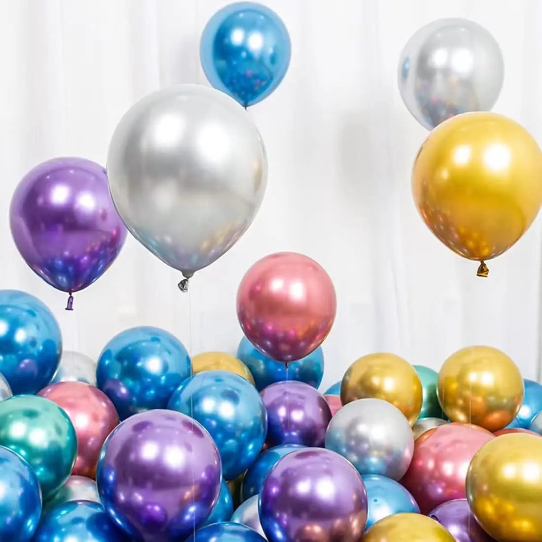 A collection of chrome metallic balloons in various shades including silver, purple, blue, and gold.