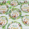 A set of green and white patterned plates featuring wildlife illustrations for a Wild One birthday party.