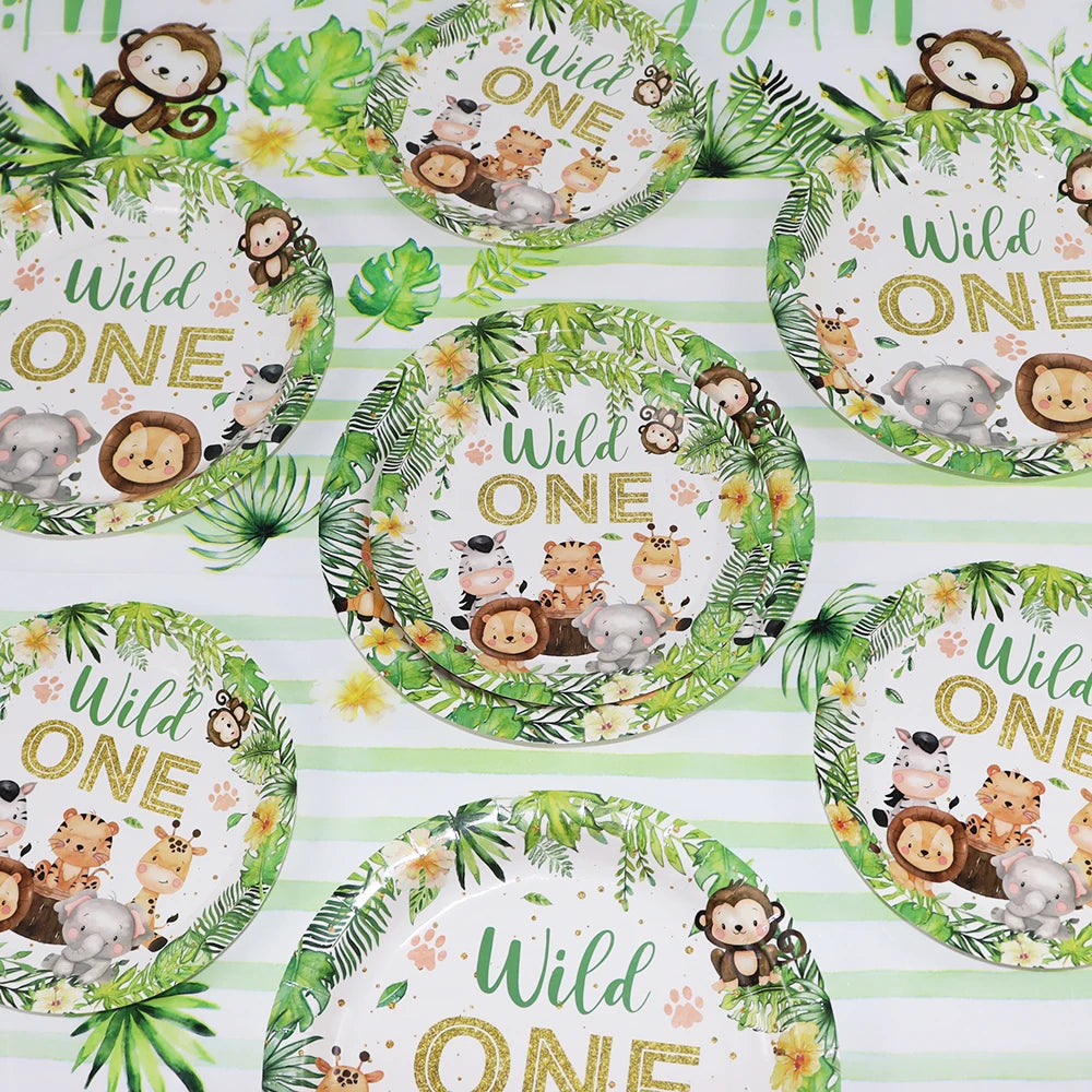 A set of green and white patterned plates featuring wildlife illustrations for a Wild One birthday party.