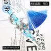 A silver gothic kunai utility knife with a blue feather and light blue decorative accents