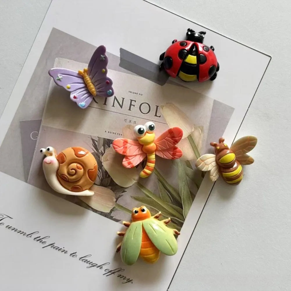 A collection of cute insect resin fridge magnets including a butterfly, bee, ladybug, snail, and dragonfly.