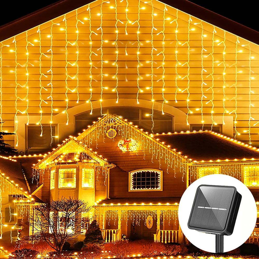 Solar LED icicle string lights illuminating a house facade and landscaping.