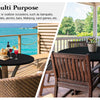 A dark round table set outdoors on a wooden deck with a glass of red wine and food, suitable for various events.