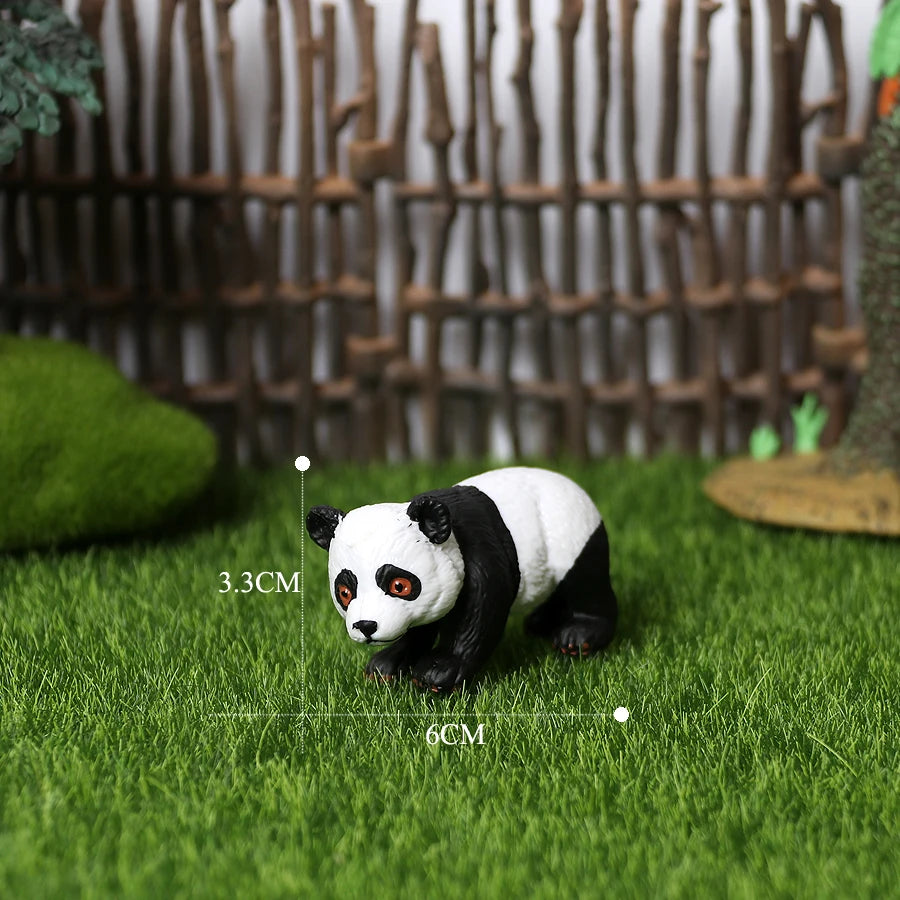 A realistic black and white panda figurine is placed on green grass with measurement lines.