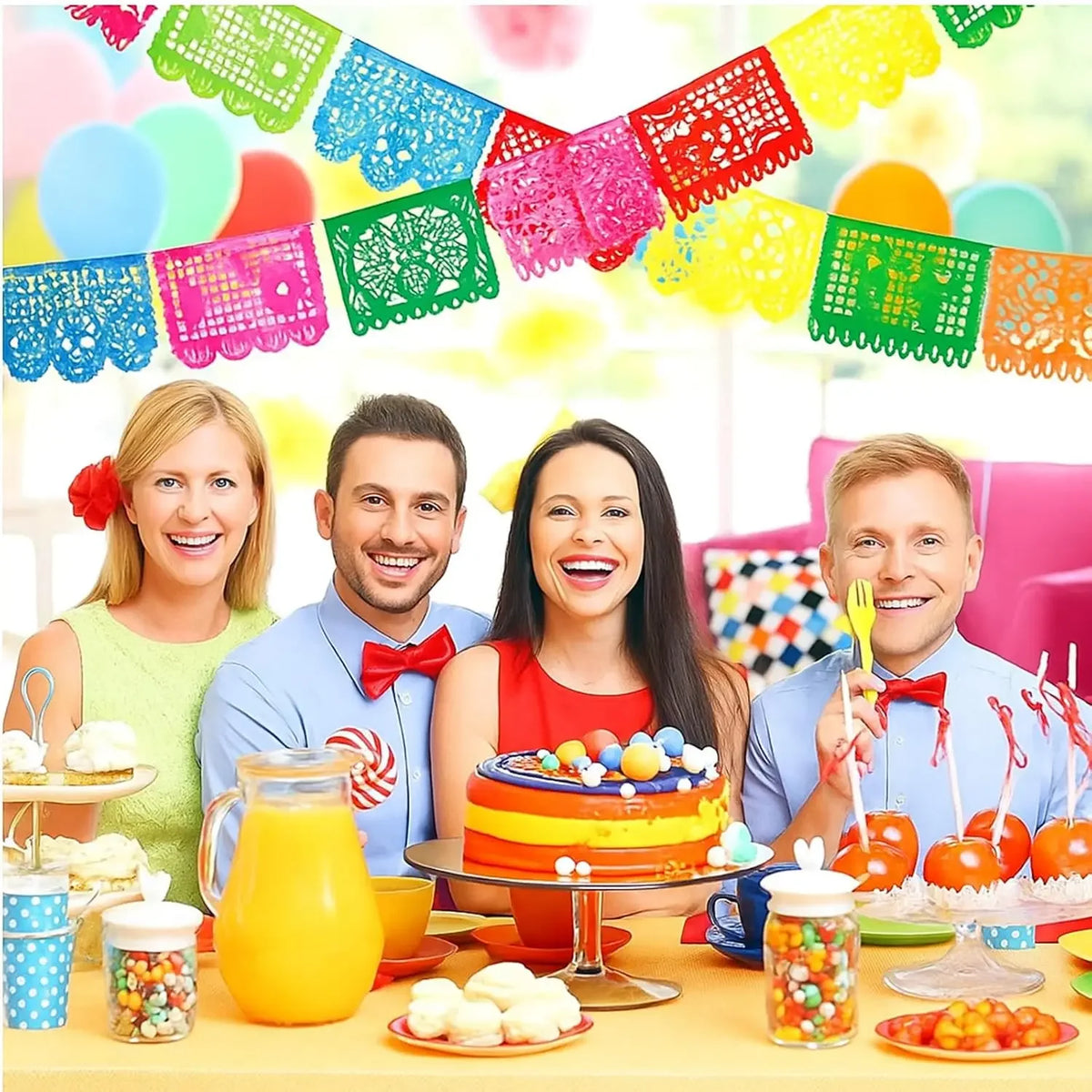 A colorful fiesta papel picado bunting banner decorated with bright paper flags and fruit on a table.