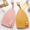 A pink cartoon PU leather key holder with a rabbit charm and a yellow tan version displayed on a white background.