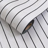 Roll of self-adhesive 3D wood grain wall panels with black stripes shown from the side