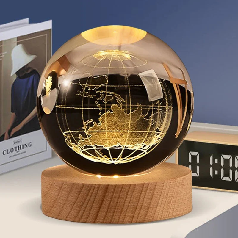 A spherical crystal ball with a gold-toned interior displaying a detailed map of the Earth on a wooden base.