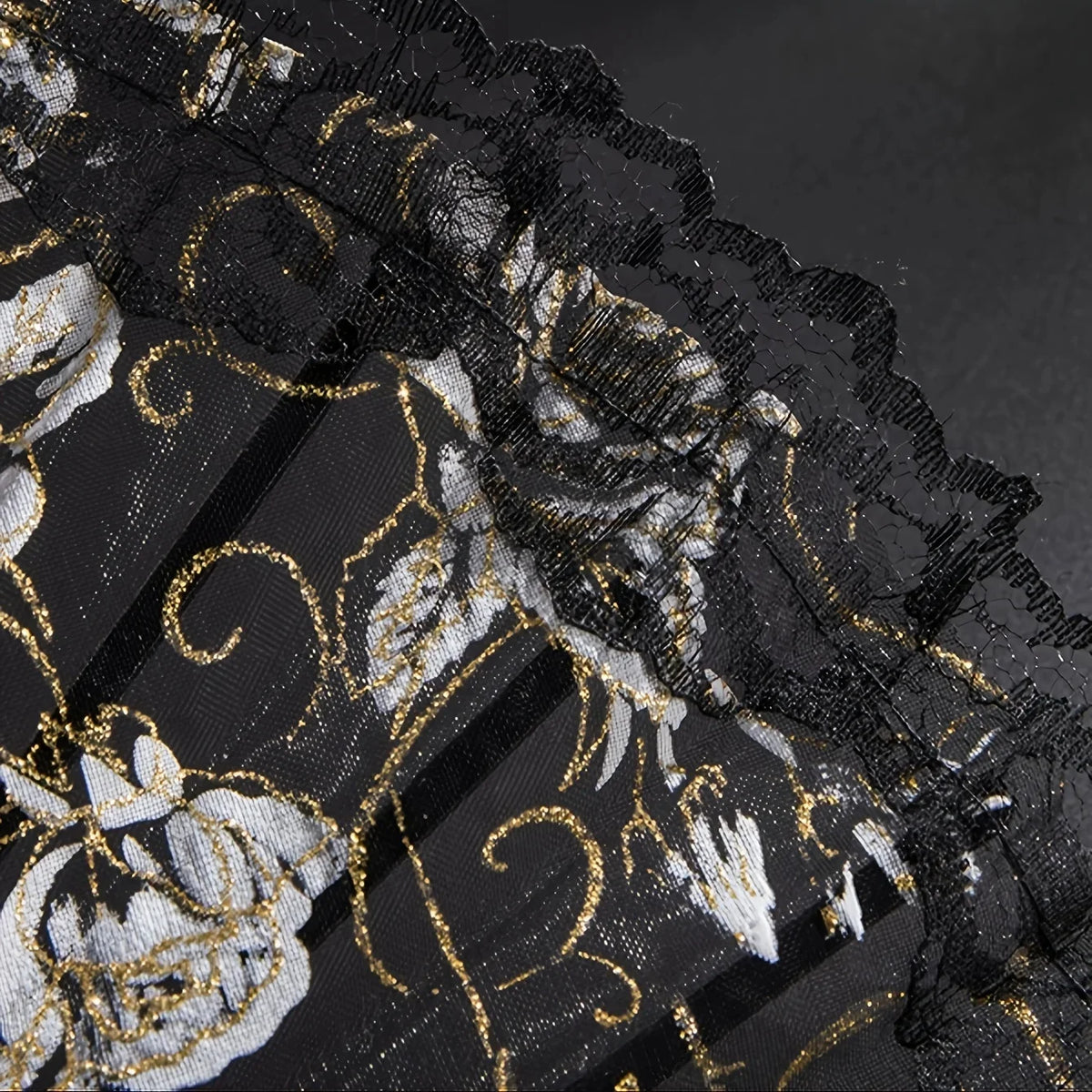 Black lace folding fan with gold and white floral embroidery