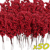A dense cluster of artificial red holly berry stems used for Christmas decoration.