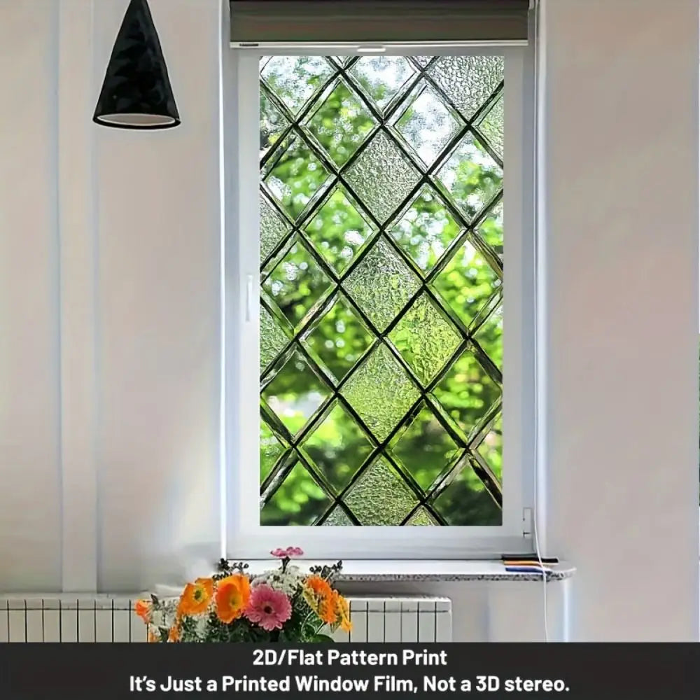 A close-up of a window covered with a diamond pattern green leaf privacy film.