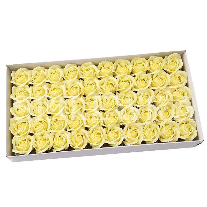 A box filled with numerous yellow artificial rose heads for wedding and party decor.