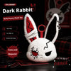 A white rabbit plush toy with red bandage markings and black ears, displayed on a dark surface.