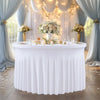 A white stretch spandex round tablecloth with a pleated skirt set up for an elegant event.