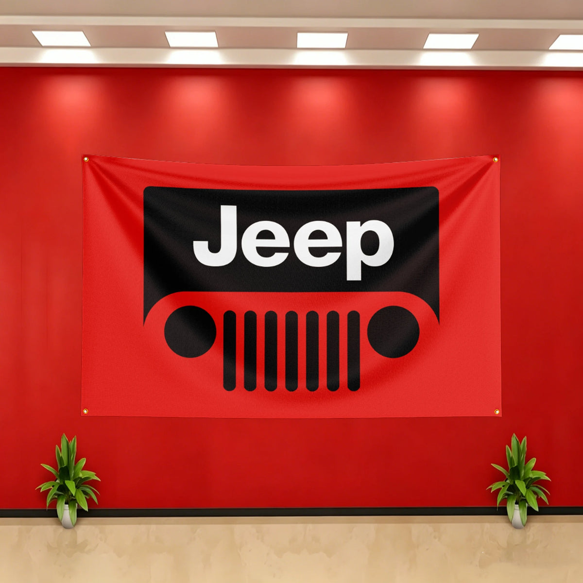 A red banner featuring the black Jeep logo displayed on a wall with potted plants below.