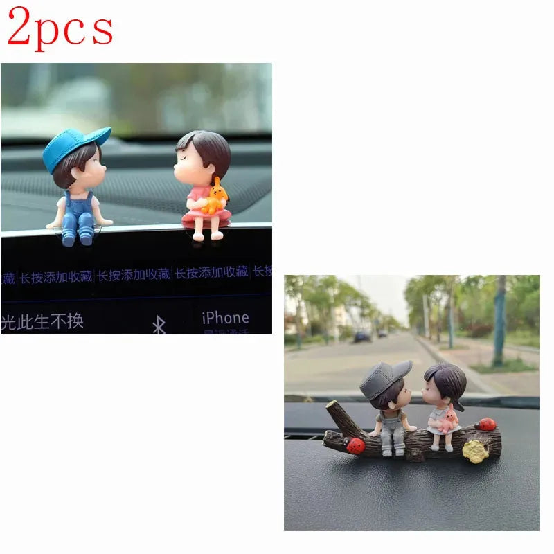 A set of two cute couple balloon car ornaments featuring a boy and a girl.