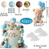 A teddy bear cake topper featuring blue and gold foam balls and clouds, with various sized balloon toppers shown.