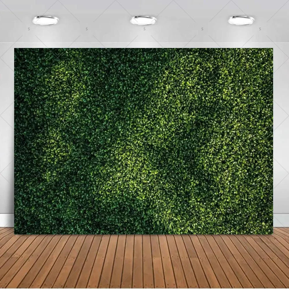 A dense, vibrant green artificial tropical palm leaf backdrop used for party decor and photography.