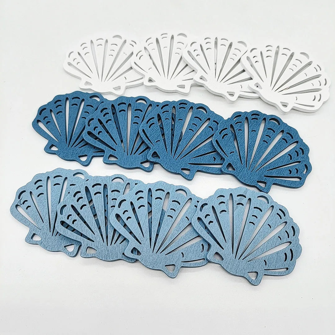 A set of twelve wooden ocean ornaments featuring various sea creatures like shells, scallops, and starfish in shades of blue-