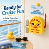 A yellow magnetic 3D printed mini mailbox with a duck design hanging on a door, next to cruise memories and sunglasses.