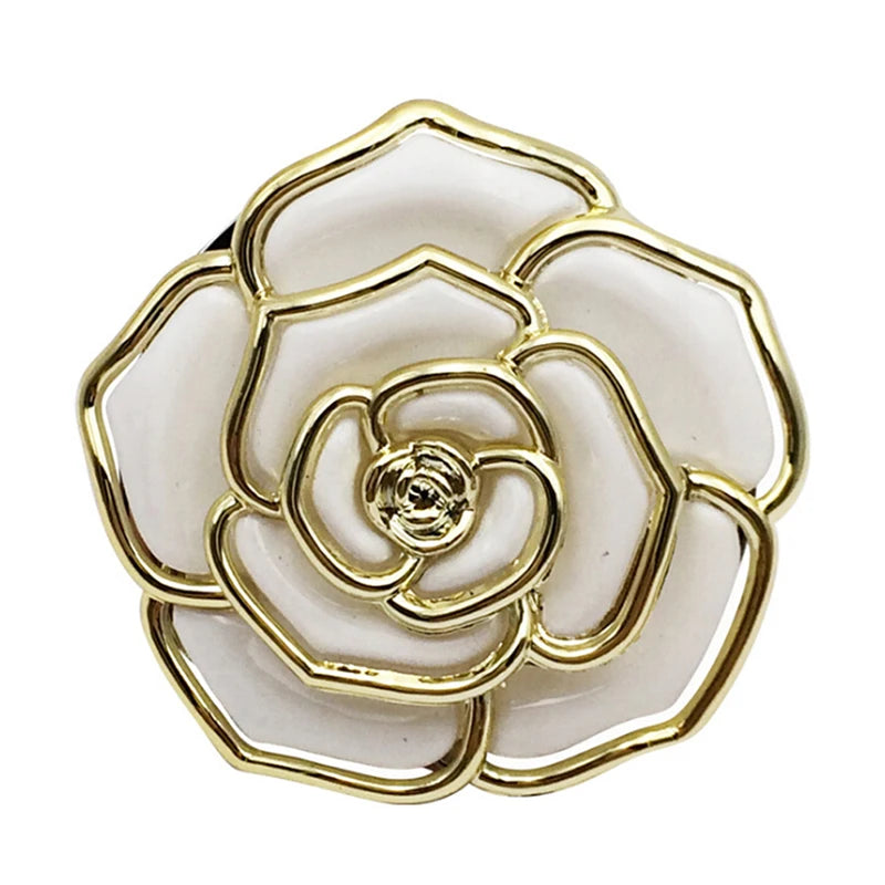 A gold-toned, layered flower shaped hook designed for folding and use on tables or desks.